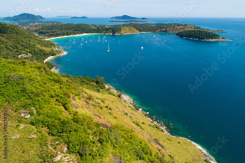 Tropical sea with wave crashing on seashore and high mountain located at Laem krating viewpoint new landmark in Phuket Thailand aerial view drone top down view