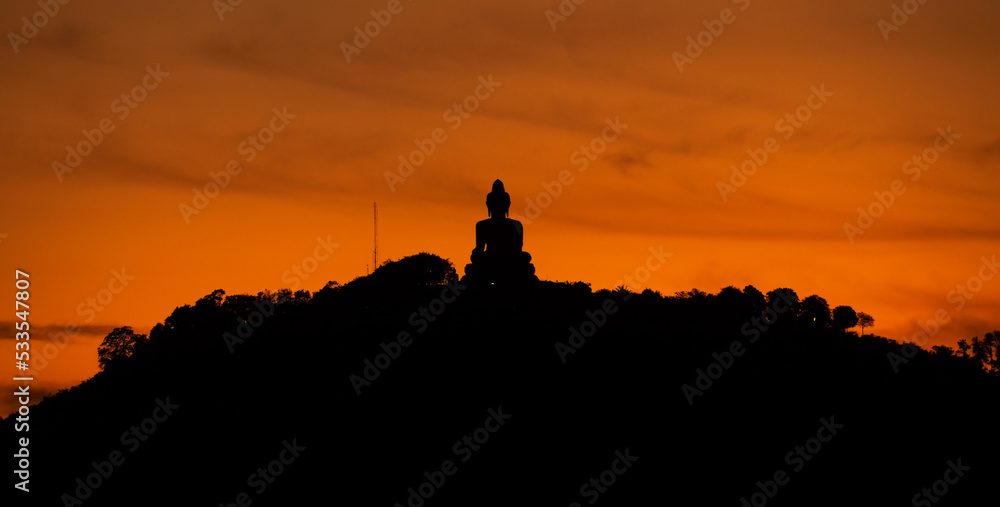 Silhouette of big buddha on high mountain in Phuket Thailand,Amazing light of sunset nature Landscape nature background Silhouette of big buddha on high mountain in Phuket Thailand,Amazing light of sunset nature Landscape nature background
