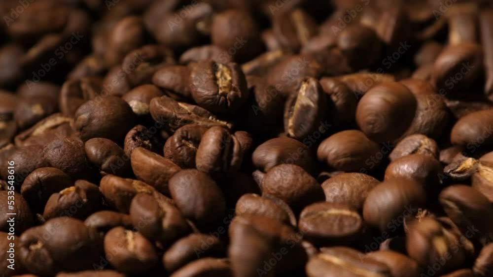 Slow motion of roasted coffee beans falling. Organic coffee seeds. Slow motion of roasted coffee beans falling. Organic coffee seeds.