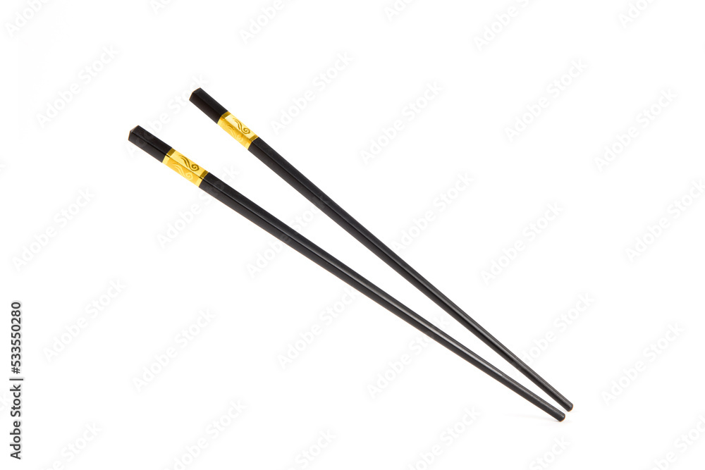 black chopsticks with golden ornamentation isolated on white background black chopsticks with golden ornamentation isolated on white background