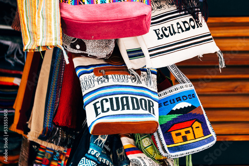colorful bags are displayed in otavalo market, ecuador photo