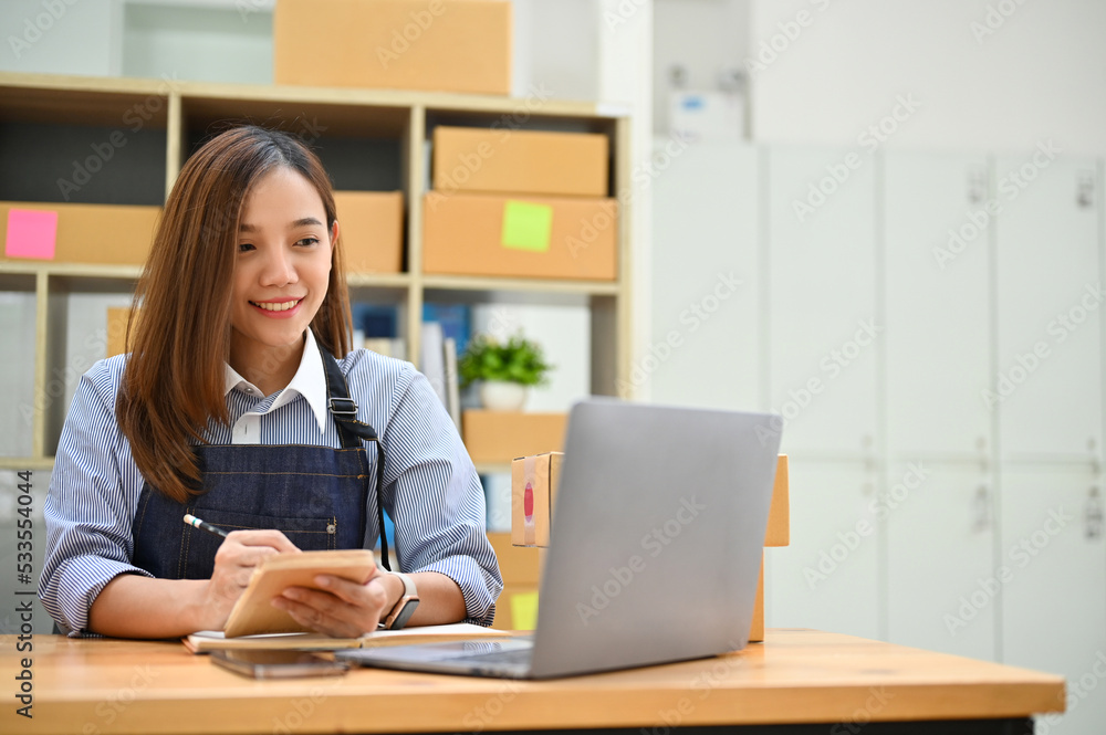 Beautiful young Asian female business startup entrepreneur working on laptop Beautiful young Asian female business startup entrepreneur working on laptop
