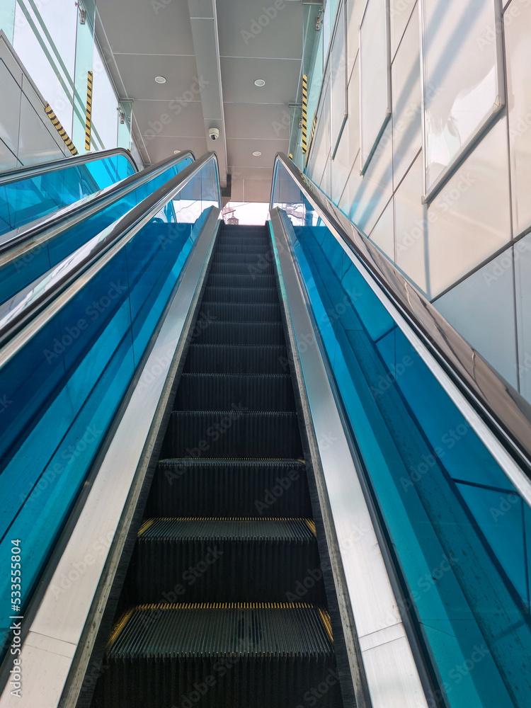 It is an escalator going up without anyone. It is an escalator going up without anyone.