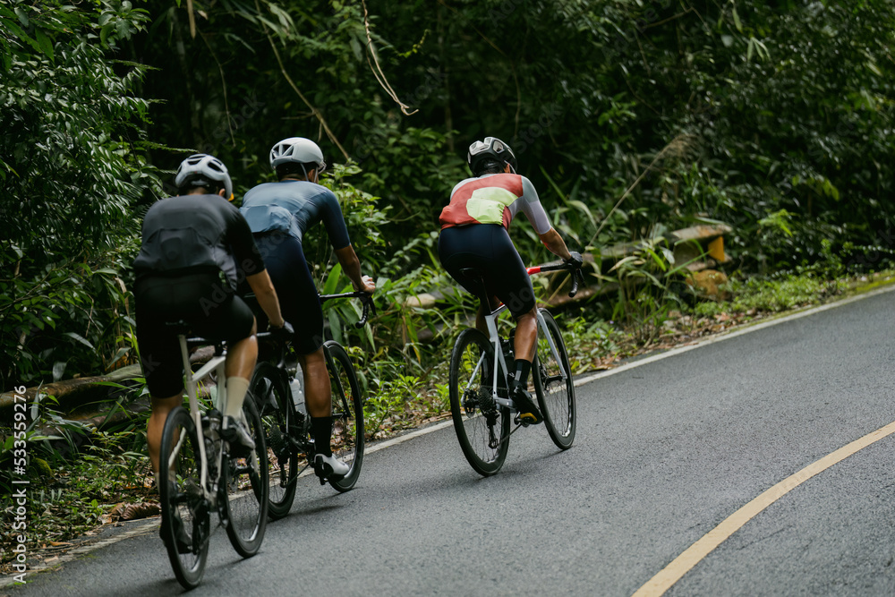 Groups of cyclists riding road bikes in the morning are climbing. Groups of cyclists riding road bikes in the morning are climbing.
