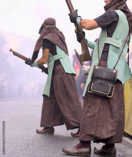 Moors and Christians fest. Two unrecognized people in arabic costume shooting fire gun blunderbuss photo