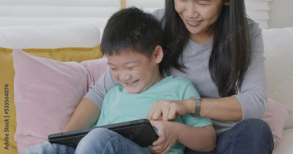 Cute smart little kid enjoy sitting on young mom's lap at sofa home relax good time play fun game on 5G wifi online phone app. Small Gen Z preschool child care in asia people by digital device gadget. Cute smart little kid enjoy sitting on young mom's lap at sofa home relax good time play fun game on 5G wifi online phone app. Small Gen Z preschool child care in asia people by digital device gadget.
