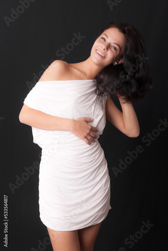 studio portrait of a girl in a white dress © Maslov Dmitry