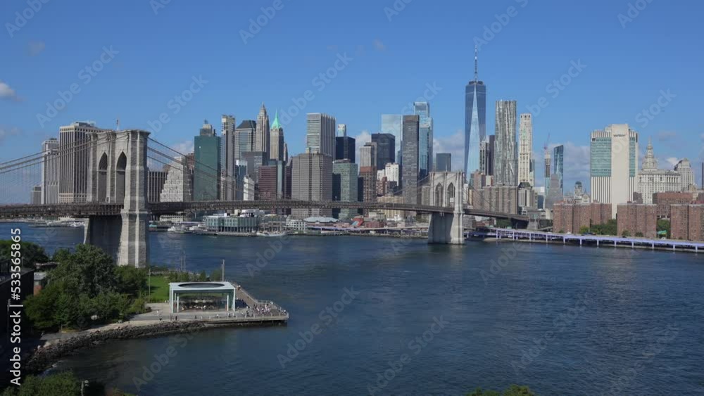 4K video with a beautiful view during a sunny day from Manhattan Bridge to Brooklyn Bridge and downtown Manhattan landmark skyscraper office building. Travel to America. New York, 2022. 4K video with a beautiful view during a sunny day from Manhattan Bridge to Brooklyn Bridge and downtown Manhattan landmark skyscraper office building. Travel to America. New York, 2022.