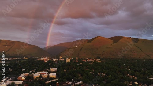 Rainbow At Sunset Over Mountains In Missoula County, Montana, USA. wide aerial photo