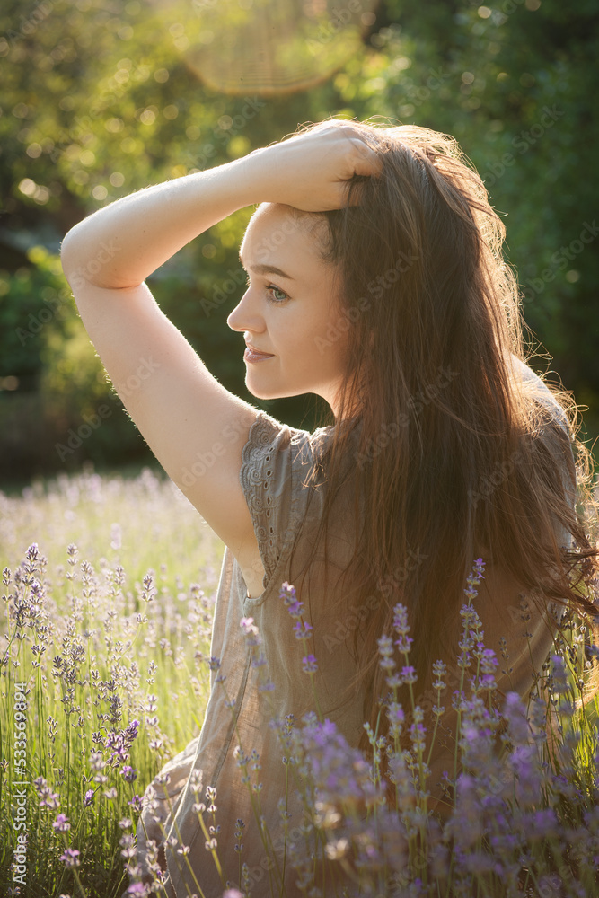 The girl sit in the middle of a lavender field The girl sit in the middle of a lavender field