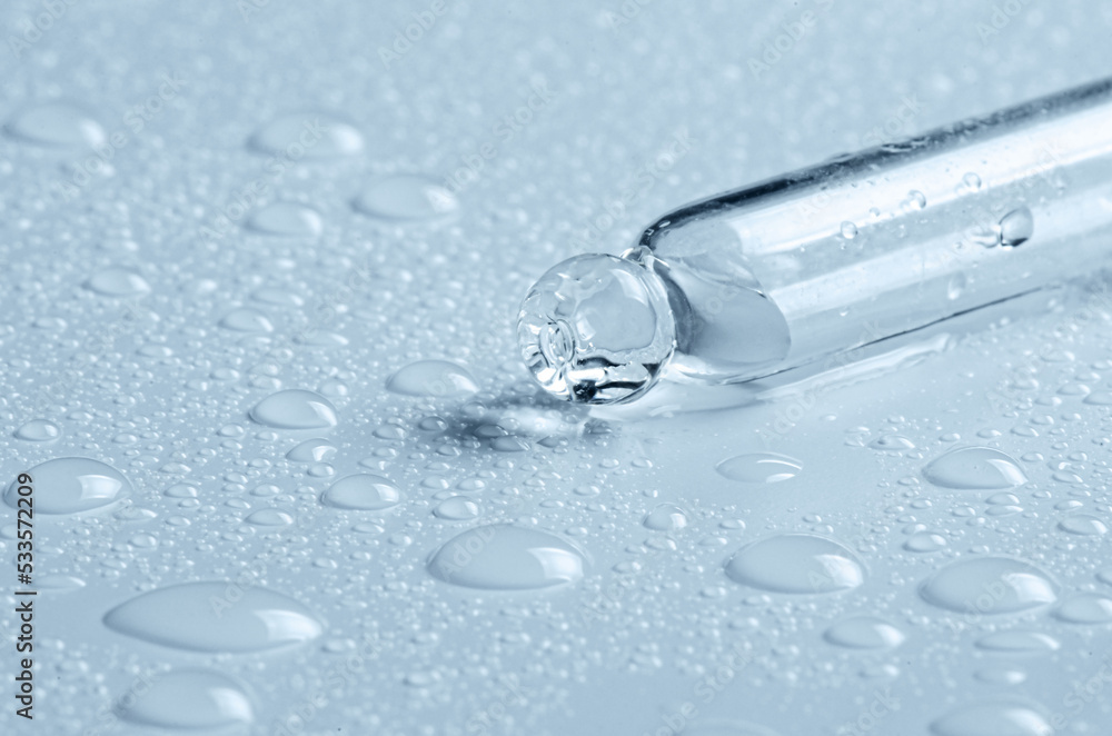 Micellar water drops and pipette. Cosmetic product for moisturizing the skin or removing makeup. Close-up, macro photography Micellar water drops and pipette. Cosmetic product for moisturizing the skin or removing makeup. Close-up, macro photography