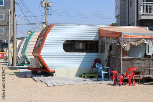 Blue beach trailer with plastic chairs