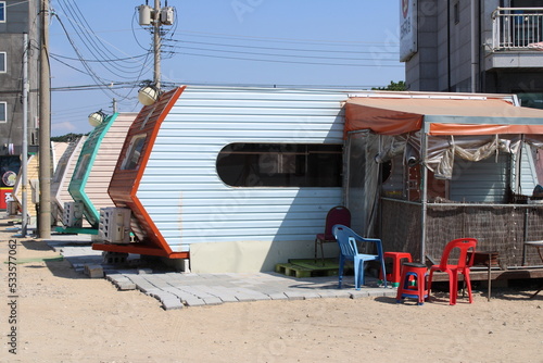 Beach camping trailer with plastic chairs 