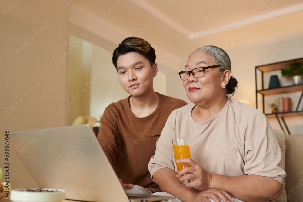 Boy Turning on Movie for Grandmother Boy Turning on Movie for Grandmother