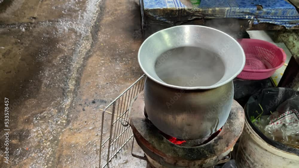 Hot boiling steam comes off from a pot on the Thai Charcoal Stove. Hot boiling steam comes off from a pot on the Thai Charcoal Stove.