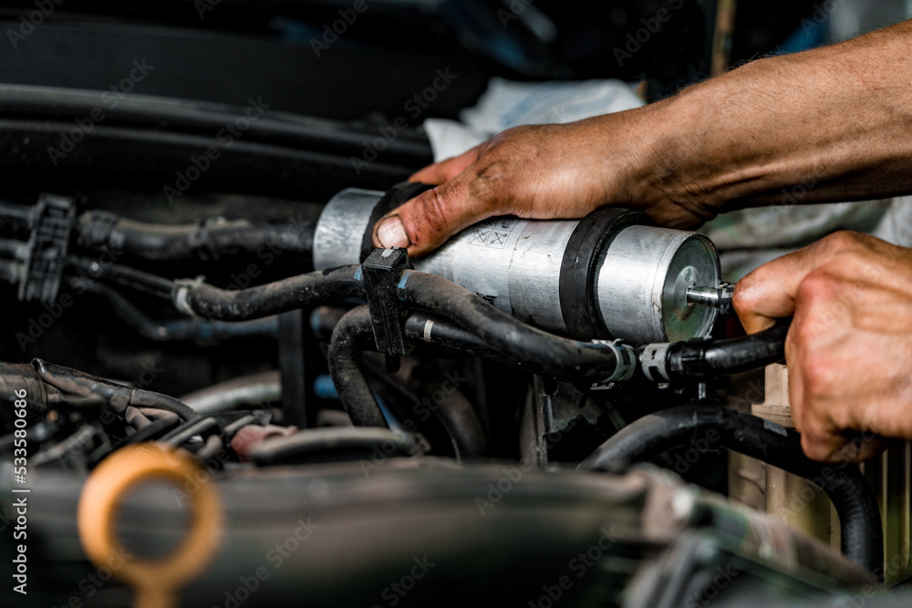 Close up of auto mechanic repairing car engine in car service Close up of auto mechanic repairing car engine in car service