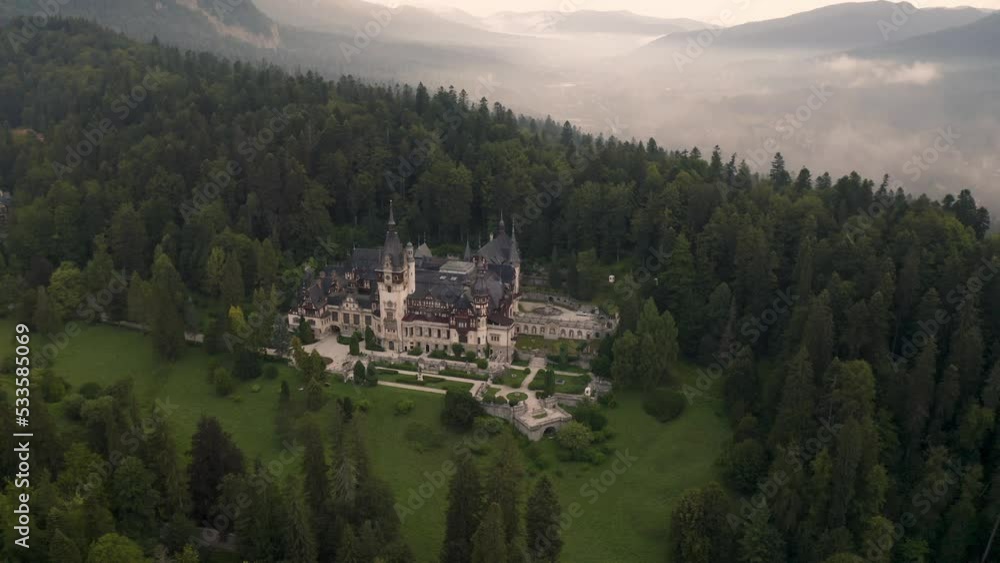 Amazing video with drone flight above beautiful Peles Castle and foggy forest around it near Sinaia, Romania Amazing video with drone flight above beautiful Peles Castle and foggy forest around it near Sinaia, Romania