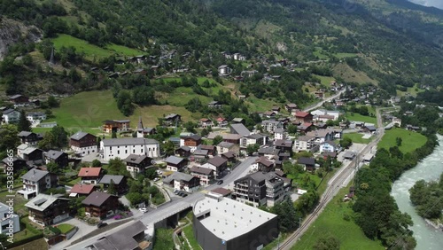 Aerial view of Mörel alpine village in Switzerland surrounded by mountains and at the bottom of the Riederalp photo