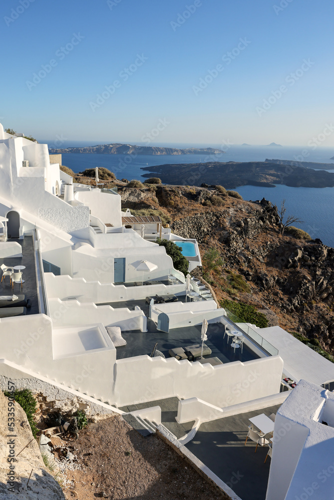 Obraz premium Whitewashed houses with terraces and pools and a beautiful view in Imerovigli on Santorini island, Greece