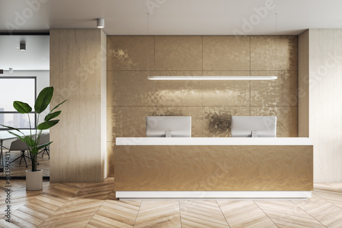 Front view on golden color reception desk in stylish office with modern computers, wall decoration and green plant on parquet floor. 3D rendering