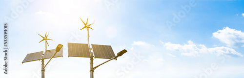 Alternative energy concept. Wind turbine with solar energy power panel, renewable photovoltaic technology. Renewable energy sources banner.