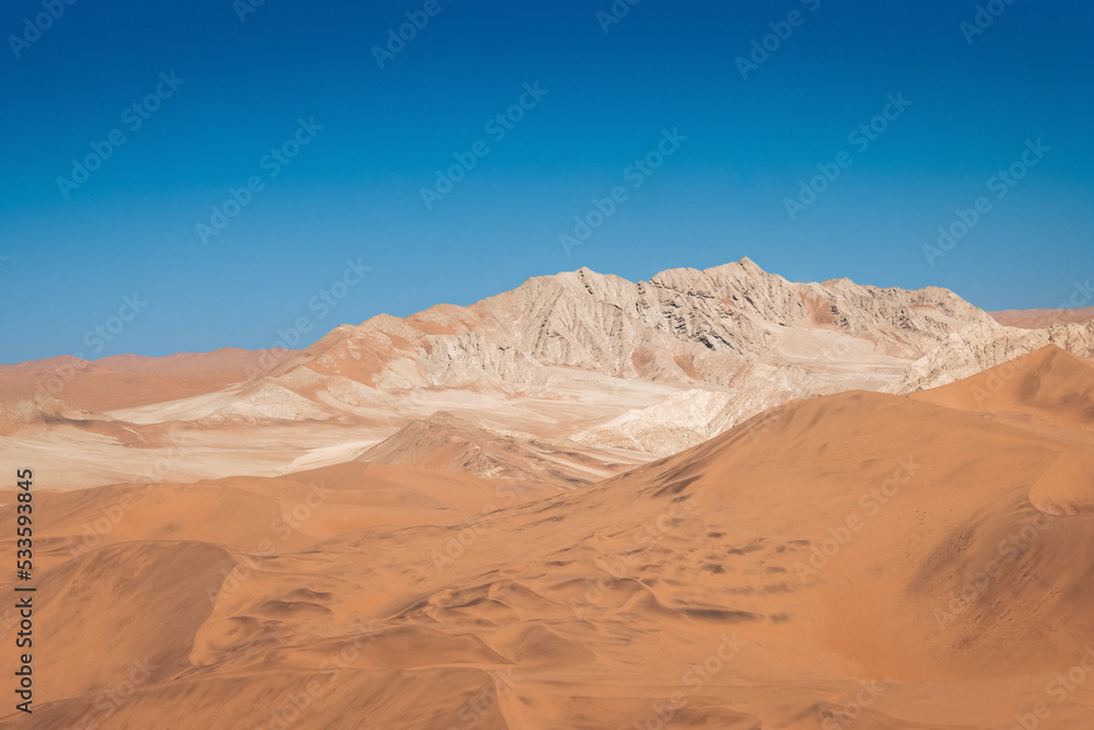 mountain in between dunes with blue sky at sossuvlei national park in Namibia, stunning wallpaper