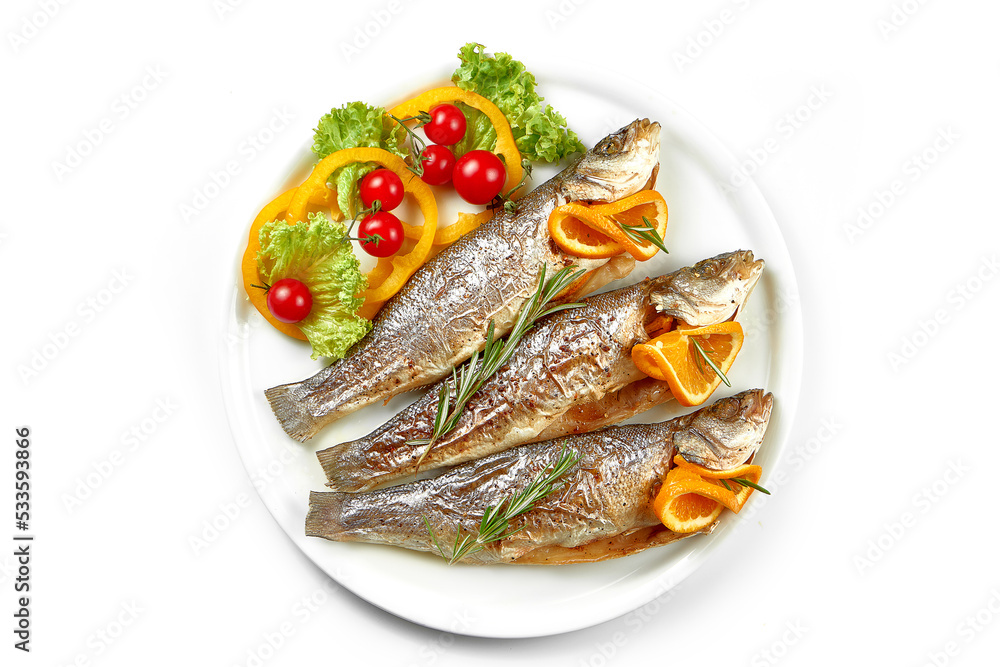Fresh marinated in spices trout fish in a white plate. White background, selective focus Fresh marinated in spices trout fish in a white plate. White background, selective focus