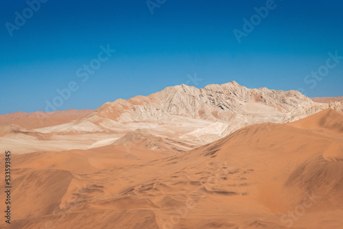 mountain in between dunes with blue sky at sossuvlei national park in Namibia, stunning wallpaper