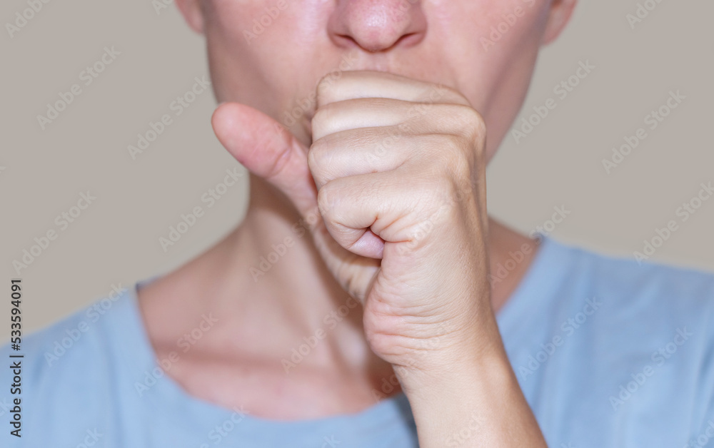 sore throat and runny nose treatment. woman using lozenge candy spray