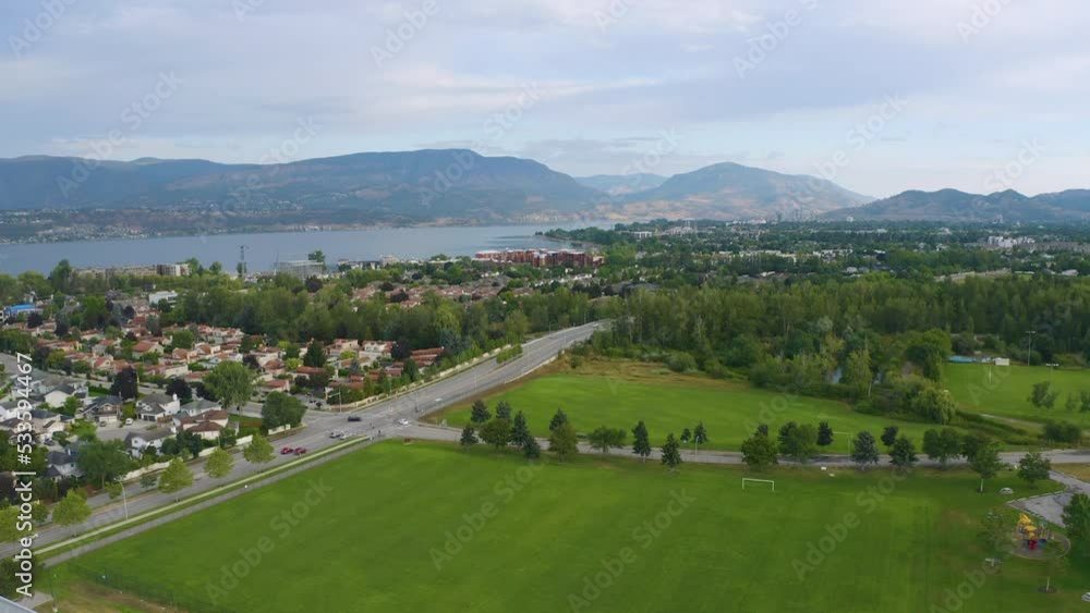 Drone view of homes and suburban sprawl near Okanagan Lake in Kelowna. Drone ascends to reveal the lake and more land in the distance. Drone view of homes and suburban sprawl near Okanagan Lake in Kelowna. Drone ascends to reveal the lake and more land in the distance.