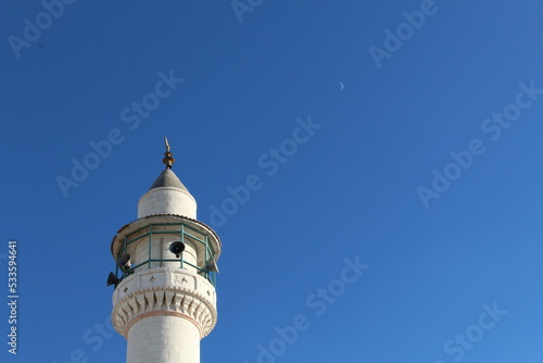 Minaret and the moon in the sky 