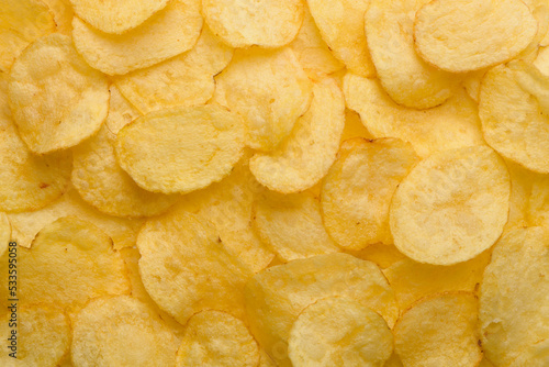 Potato chips with salt texture top view pattern background