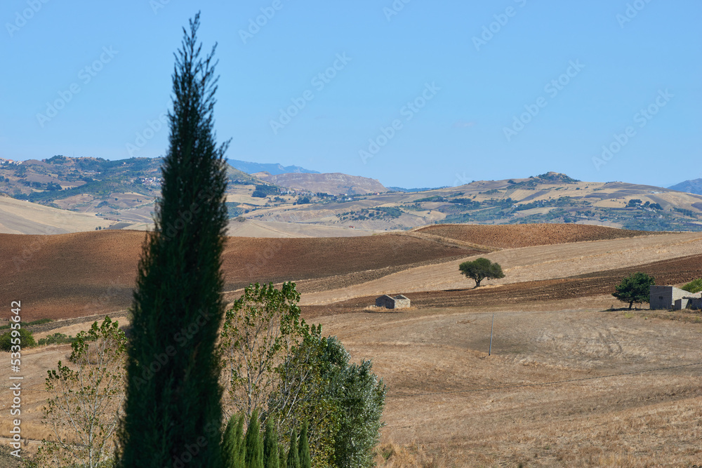 Obraz premium rural landscape with farmhouse in central sicily in midsummer with gold-colored fields