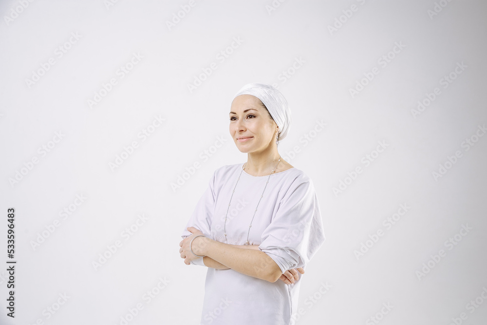 Portrait of a girl in a hijab in white clothes against a white background Portrait of a girl in a hijab in white clothes against a white background