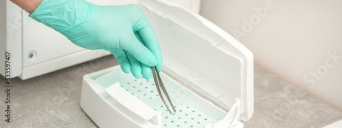 Hand disinfects tweezers with cleaning systems for medical instruments. Ultrasonic cleaner