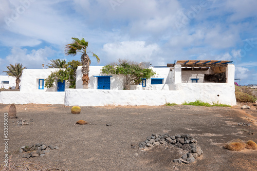Typical white house on La Graciosa island, with desert vegetation, Lanzarote, Canary Islands, Spain.