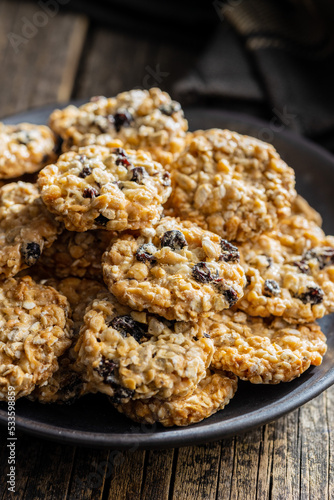 Wholegrain oat cookies. Cookies with oatmeal and raisins on wooden table.