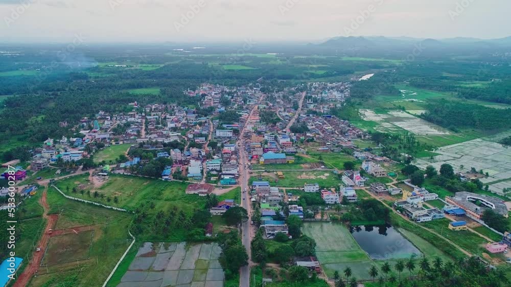 A top aerial view of small town amidst paddy fields and agricultural lands A top aerial view of small town amidst paddy fields and agricultural lands