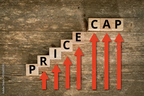 Price Cap on rising letters placed on wooden background with red arrows pointing upwards