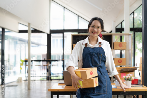 Startup small business entrepreneur SME freelance woman working with box, Young asian online market packing box delivery, SME delivery e-commerce telemarketing seller concept.