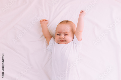 The baby stretches after sleeping Lifestyle . A happy child. Children's article.