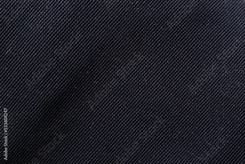Black fabric with a beautiful shade, macro. Fashion