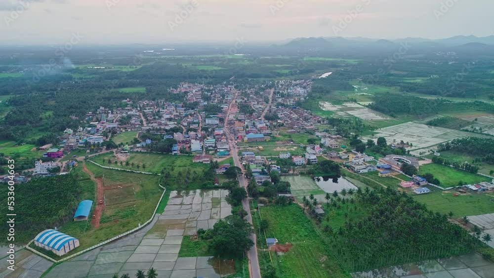 A top aerial view of small town amidst paddy fields and agricultural lands A top aerial view of small town amidst paddy fields and agricultural lands