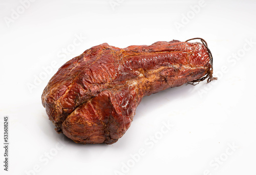 Gammon, smoked ham - in one piece, horizontal view, isolated on a white background. Polish cold cuts, a packshot photo.