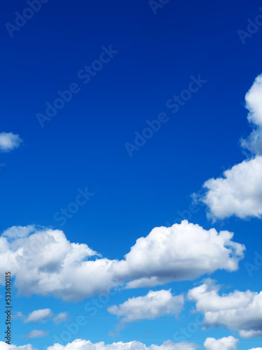 Blue sky with clouds background. Bright blue sky in summer.