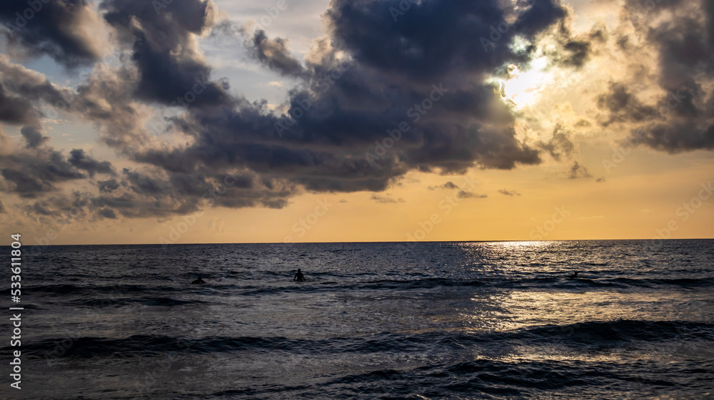 Surfing in the sunset light in Sardinia