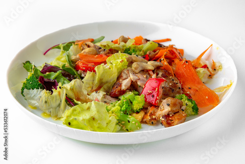 Salad of vegetables and nuts. Balanced, nutritious, tasty and nutritious food. Ready-made menu for a restaurant or for delivery. Dish in a white plate isolated on a white background.