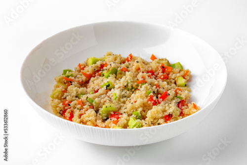 Millet porridge with vegetables. Balanced, nutritious, tasty and nutritious food. Ready-made menu for a restaurant or for delivery. Dish in a white plate isolated on a white background.