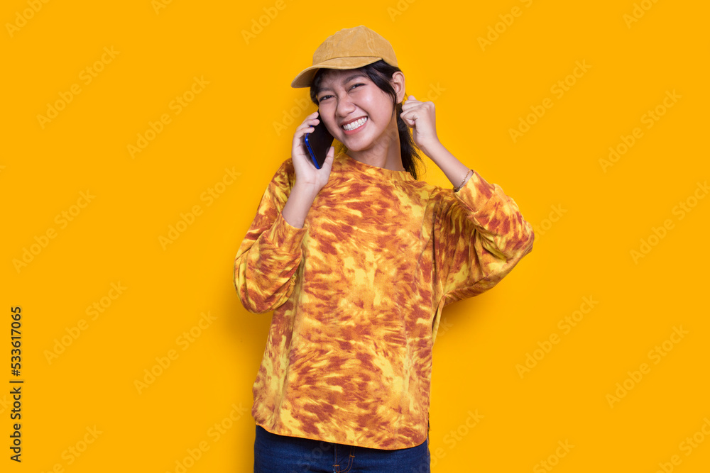 happy young asian beautiful woman using mobile phone isolated on yellow background
happy young asian beautiful woman using mobile phone isolated on yellow background
