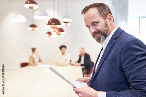 Business man as a manager or consultant smiles mischievously